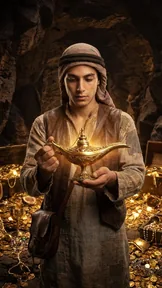 An adult adventurer in worn brown clothing holding a glowing golden lamp in a treasure cave.